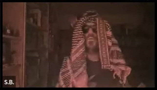 YouTube.com: S.B. Alger is mocking the Arab by having a towel on his head in a YouTube live stream, knowing that Tracy's widower would witness his shameful activity.